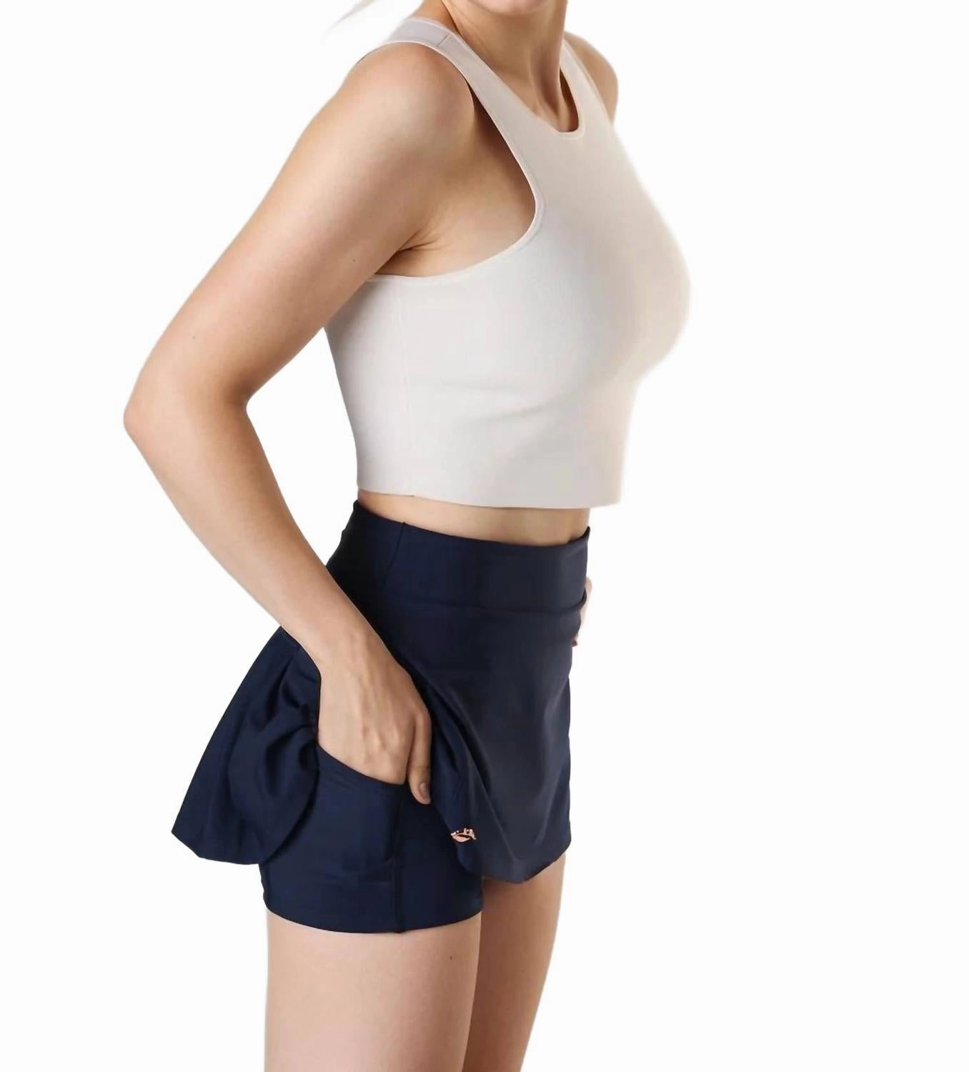 Pleated Golf Skirt In Navy rooftop party look